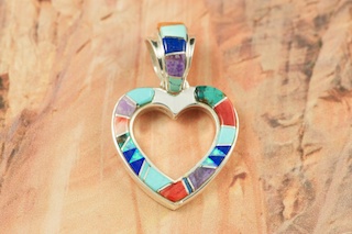 Genuine Sleeping Beauty Turquoise, Spiny Oyster Shell and Sugilite inlaid between ribbons of Sterling Silver. Stunning Heart Design Pendant with Fire and Ice Lab Opal accents. Free 18" Sterling Silver Chain with Purchase of Pendant. Created by Navajo Artist Vernon Smith. Signed.